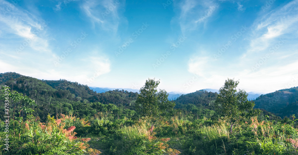World environment day concept: Green mountains and beautiful blue sky clouds
