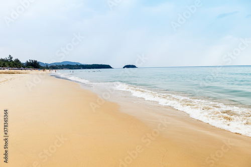 Beautiful clean beach on Phuket island in south of Thailand, summer holiday break destination to Asia, Tourist on the beach, cloudy sky with blue sea water