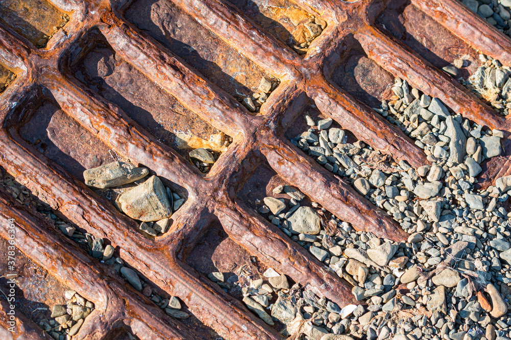 Rusty iron on pebble beach, Falkland Islands Rusty iron on pebble beach, Falkland Islands