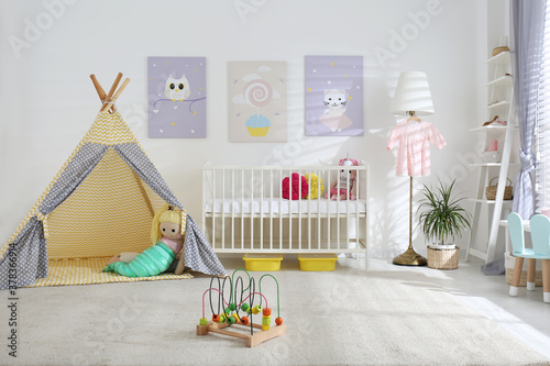 Baby room interior with cute posters, play tent and comfortable crib