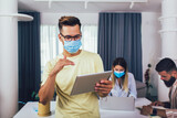 Students studies at home, wear protective masks, and using digital tablet.