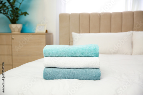 Soft clean towels on bed at home © New Africa