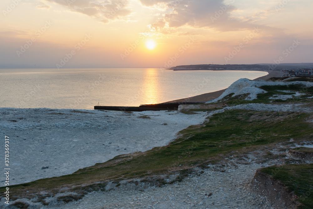 Seaford, East Sussex, England. View of the white chalk cliffs to the west in the evening sunset, part of Seven Sisters National park, selective focus Seaford, East Sussex, England. View of the white chalk cliffs to the west in the evening sunset, part of Seven Sisters National park, selective focus