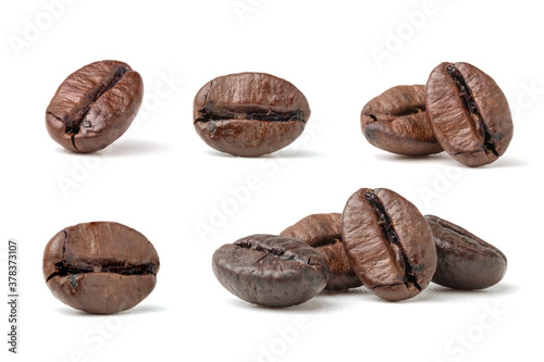 Collection of fresh roasted dark brown arabica coffee beans isolated on a white background with clipping path.