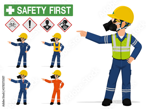 An industrial worker with respirator is pointing to something.