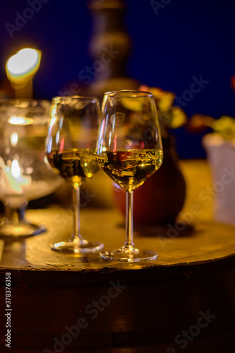 Two glasses of cold dry white wine served outdoor in cafe at night in Italy