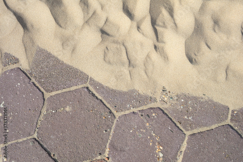Detail of pavement and sand at the promenade