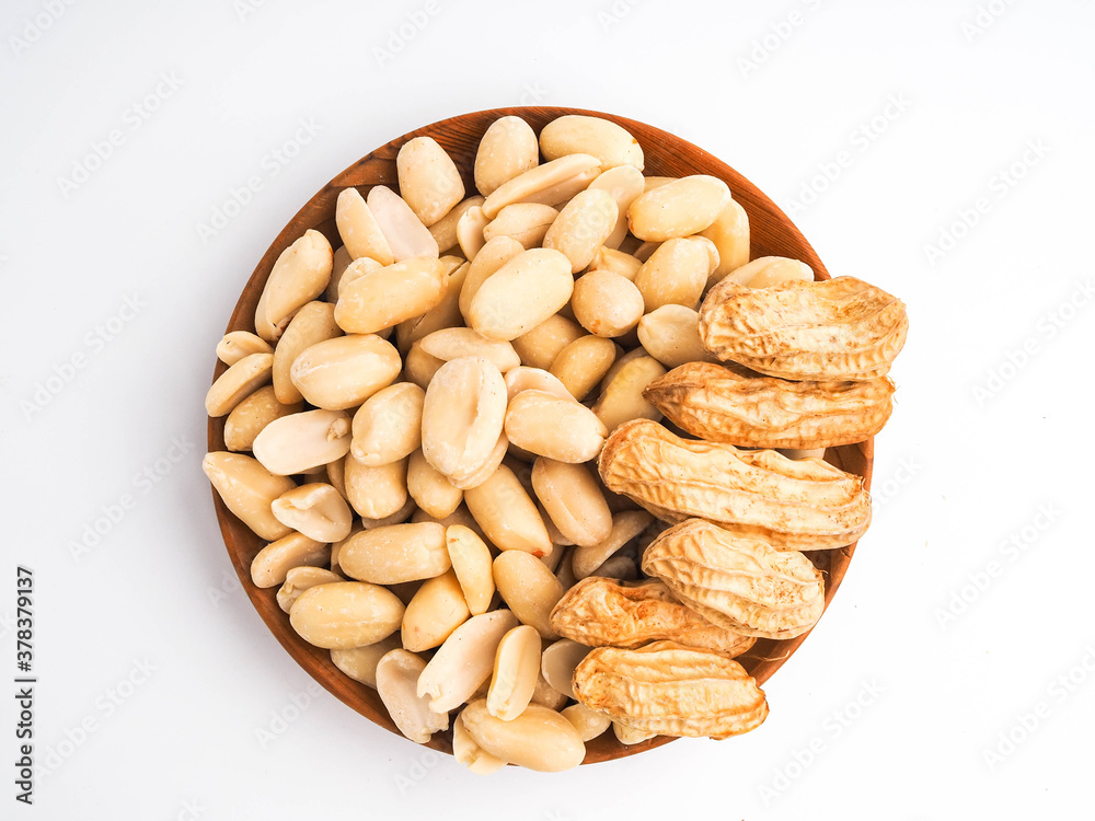 Peanuts in a wooden bowl on white background Peanuts in a wooden bowl on white background