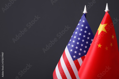 Closeup view of USA and China flags on dark background, space for text. International relations