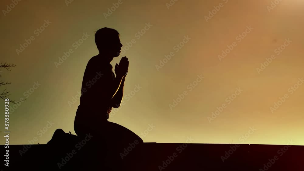 Religious man bows on sunset
