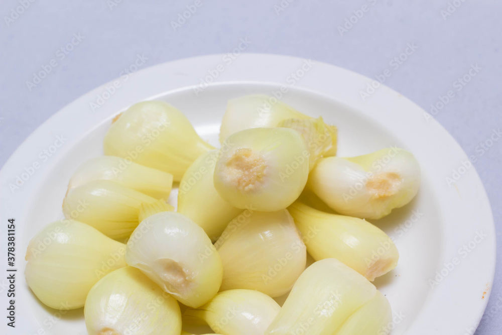 three pickled onions with parsley on white background three pickled onions with parsley on white background