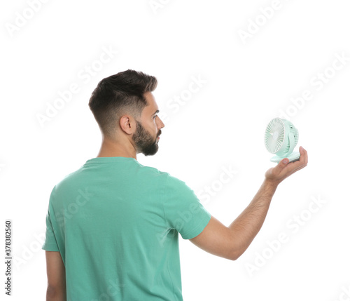 Man with portable fan on white background. Summer heat