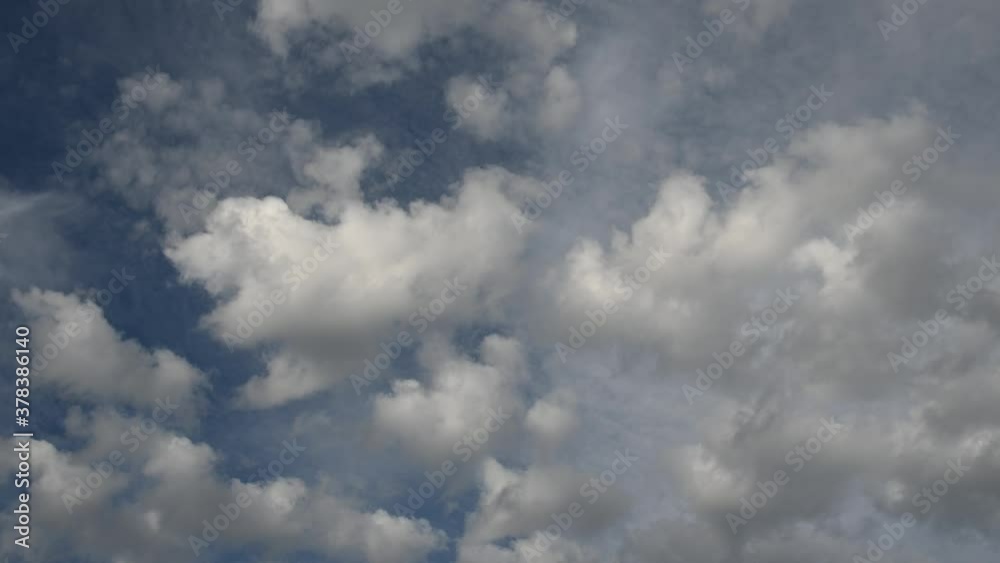 Time lapse of fluffy white and grey storm multi-layered clouds moving through a bright blue sky.
Time lapse of fluffy white and grey storm multi-layered clouds moving through a bright blue sky.