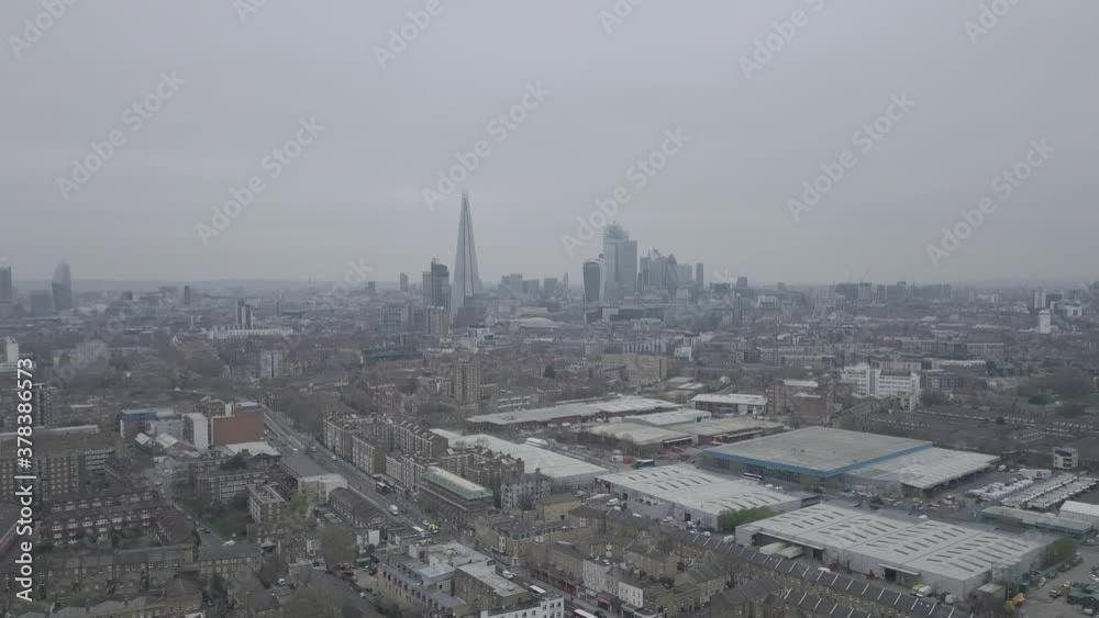 London Skyline Aerial Push Out Shot with Residential area in foreground. Buildings and homes on a cloudy day with London Skyline London Skyline Aerial Push Out Shot with Residential area in foreground. Buildings and homes on a cloudy day with London Skyline