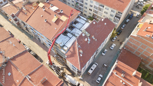 Aerial view of the building Construction in the city center. Pouring concrete using a crane.