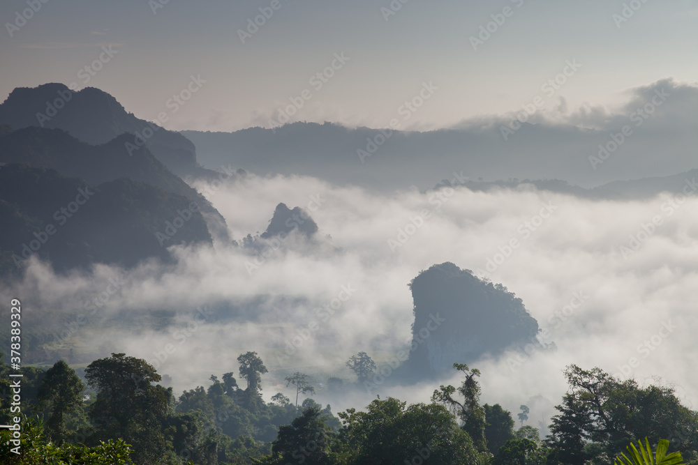 Morning mist above mountain againts sky