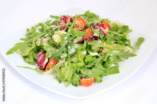 Fresh vegetable salad with tomatoes, parmesan and arugula