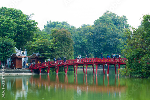 The Huc Bridge or Sun shine bridge at Hoan Kiem Lake, It`s a red wooden arch bridge. 