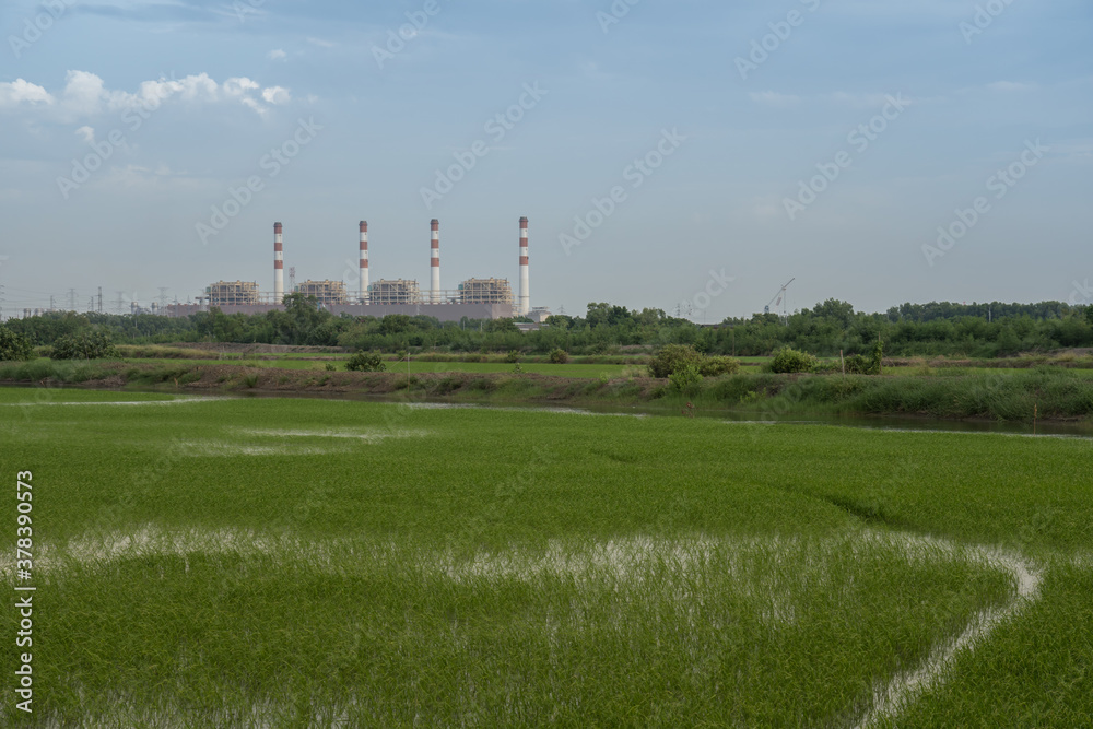 Power plant with green field againts sky Power plant with green field againts sky