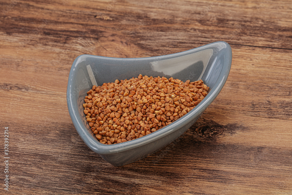 Raw buсkwheat cereal in the bowl Raw buсkwheat cereal in the bowl