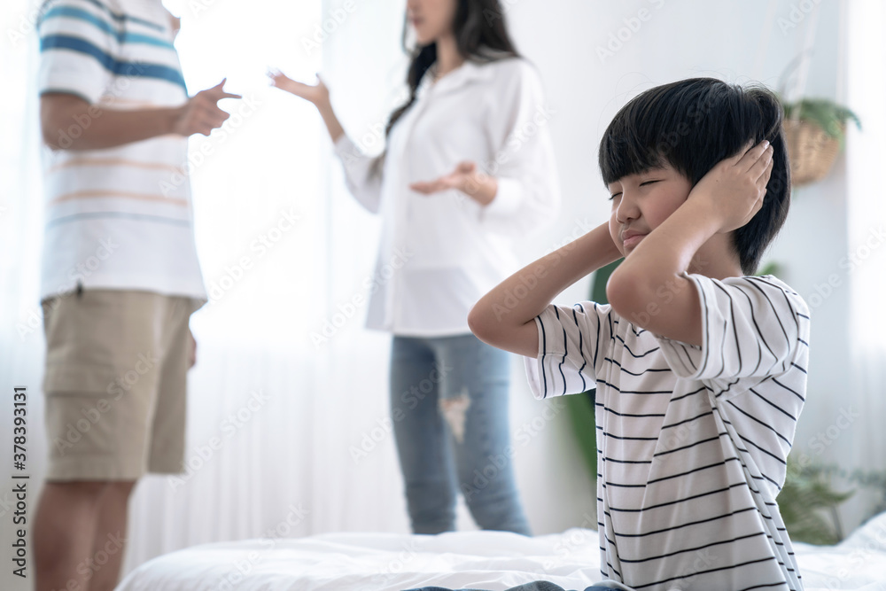 Crying illtle asian boy with his fighting parents in the background, Family problems, Divorce problem. Crying illtle asian boy with his fighting parents in the background, Family problems, Divorce problem.