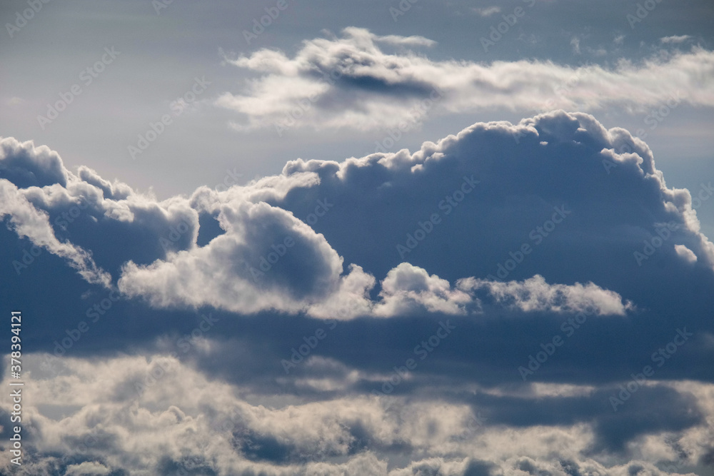 Dark blue sky on which there are contrast blue clouds, abstract background Dark blue sky on which there are contrast blue clouds, abstract background