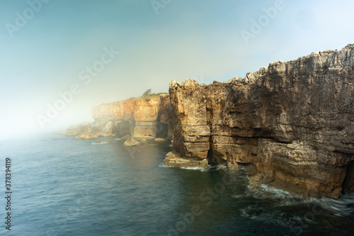 the sea breaking against the cliffs