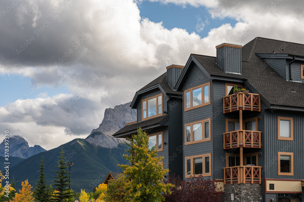 Wooden building with rocky mountains in autumn forest on downtown at Canmore