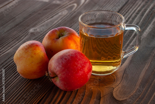 a glass of an apple juice on a wooden table