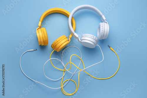 Two headphones over blue background. Music concept.