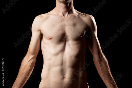 A skinny muskular man with funnel or sunken chest, better known in medicine as Pectus Excavatum. Front view with arms down.