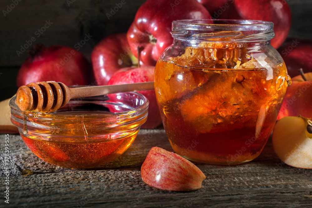 Jewish holiday Rosh Hashanah. Apples and honey on the rustic wooden table. Vintage style composition on a rustic wooden background. Jewish holiday Rosh Hashanah. Apples and honey on the rustic wooden table. Vintage style composition on a rustic wooden background.