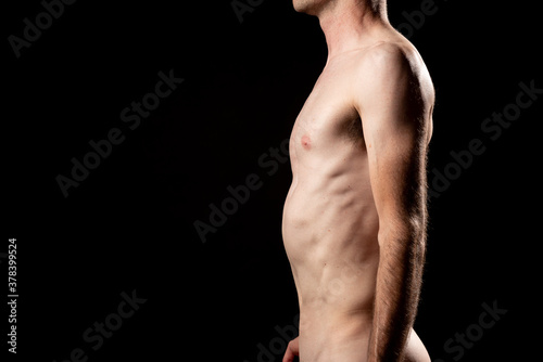 Side view of a fibrous nude man with sunken chest or Pectus Excavatum.