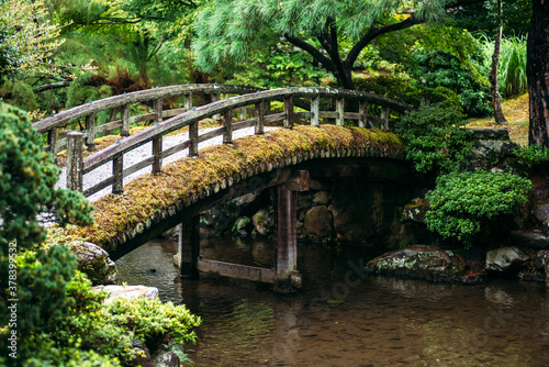 Japan, Kyoto,ÔøΩFootbridge over pond in Japanese garden