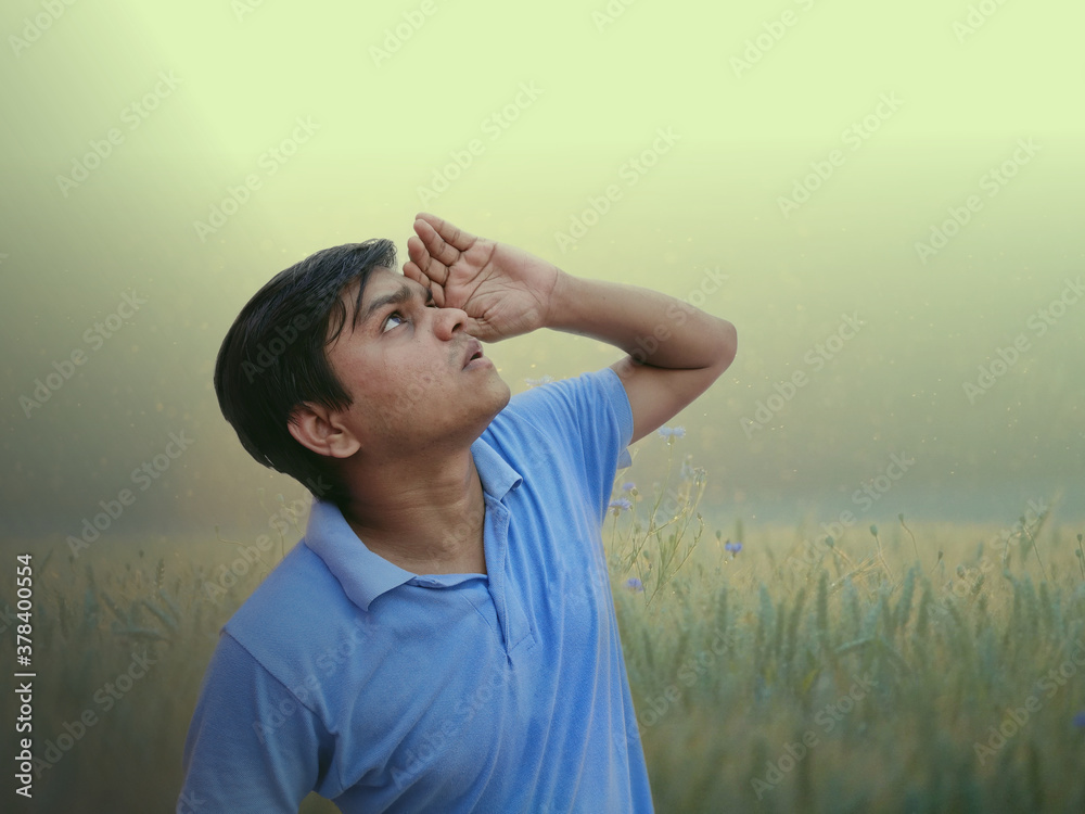 Man lookup clouds hoping for rain in fields Man lookup clouds hoping for rain in fields
