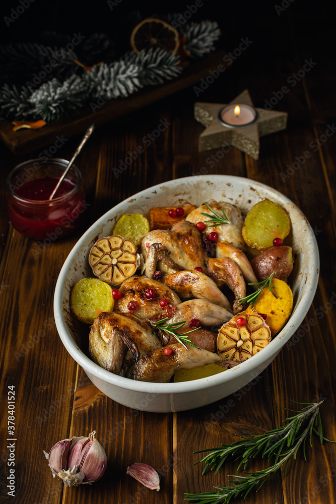 Baked quails with potatoes and cranberry sauce, thanksgiving or christmas food Baked quails with potatoes and cranberry sauce, thanksgiving or christmas food