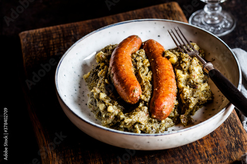 Plate of smoked sausages with kale