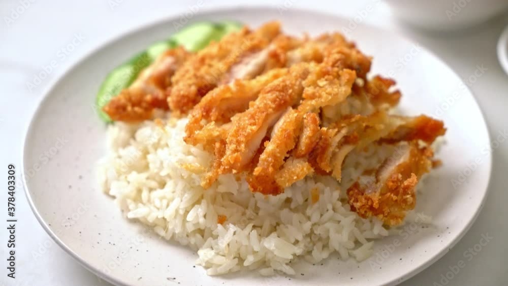 Hainanese chicken rice with fried chicken or rice steamed chicken soup with fried chicken - Asian food style Hainanese chicken rice with fried chicken or rice steamed chicken soup with fried chicken - Asian food style