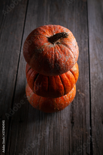 Decorative pumpkins on dark wooden background. Happy Halloween concept.