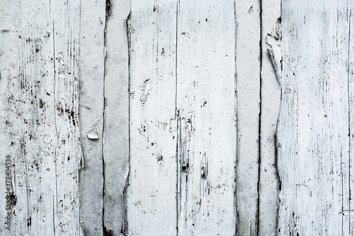 Part of wooden wall made of wooden planks and painted into white