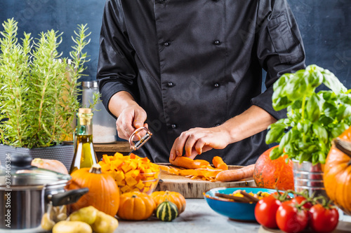 cropped shot of chef chopping ingredients for pumpkin soup