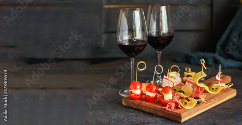glass of wine and snack canapes cheese vegetables snack plate serving size natural product portion top view place for text copy space food background rustic