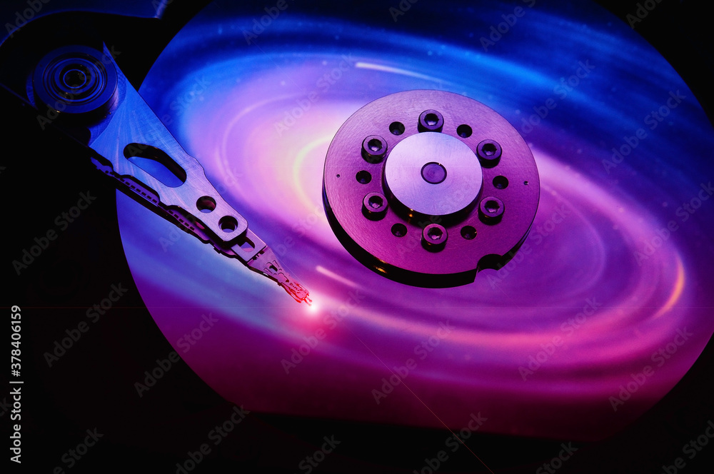 closeup of computer open hard disk drive with colored abstract effect reflected closeup of computer open hard disk drive with colored abstract effect reflected