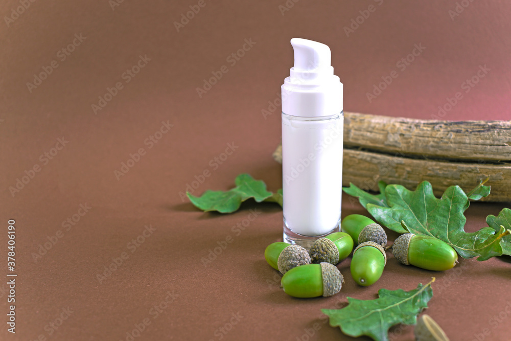 Cosmetic bottle container with green acorns, oak leaves and wood. Natural beauty product concept. Skin care, organic cosmetics, vegan cosmetics. Copy space. Acorn natural cosmetics. Cosmetic bottle container with green acorns, oak leaves and wood. Natural beauty product concept. Skin care, organic cosmetics, vegan cosmetics. Copy space. Acorn natural cosmetics.