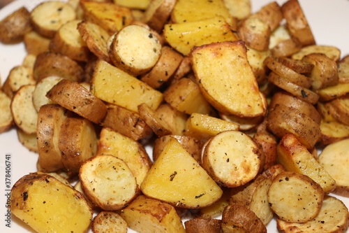 Chopped roasted potatoes on plate close up