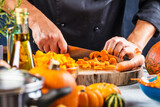 cropped shot of chef chopping ingredients for pumpkin soup