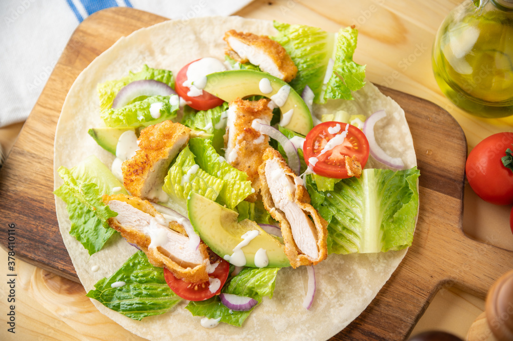 crispy chicken wrap on wooden board crispy chicken wrap on wooden board