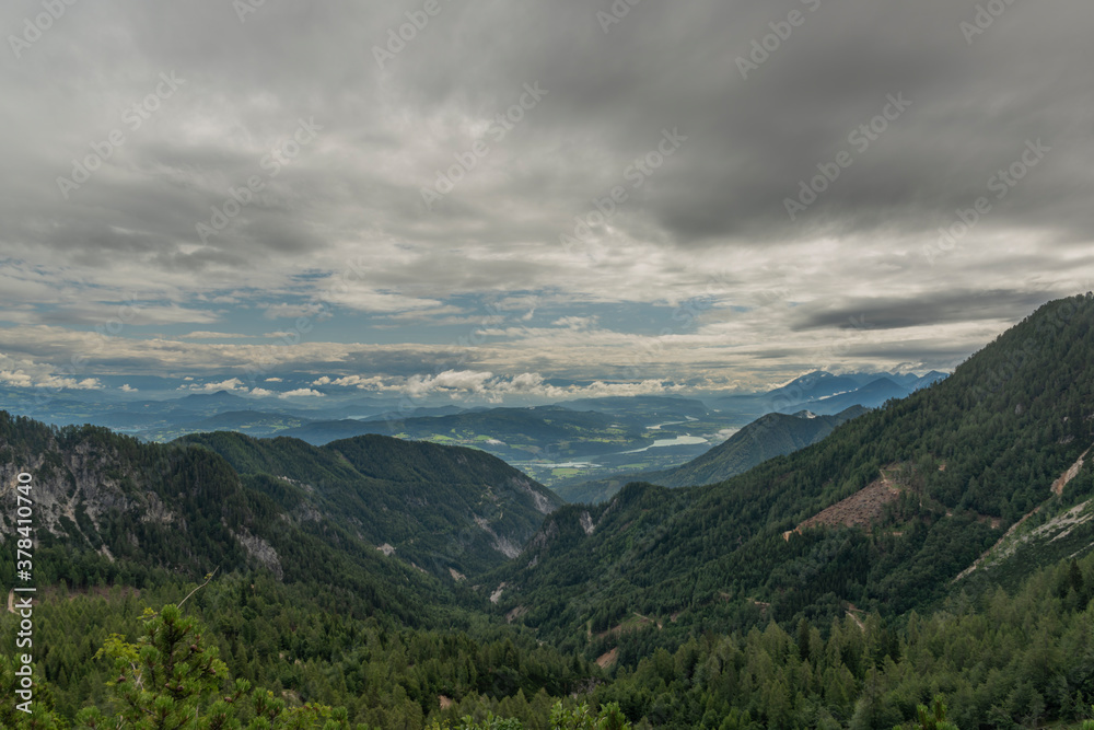 View on Drau river valley from path to Mittagskogel hill in cloudy summer day