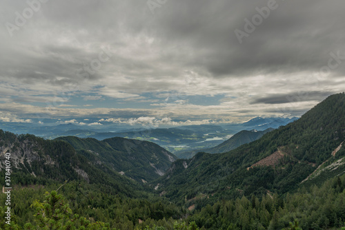 View on Drau river valley from path to Mittagskogel hill in cloudy summer day © luzkovyvagon.cz