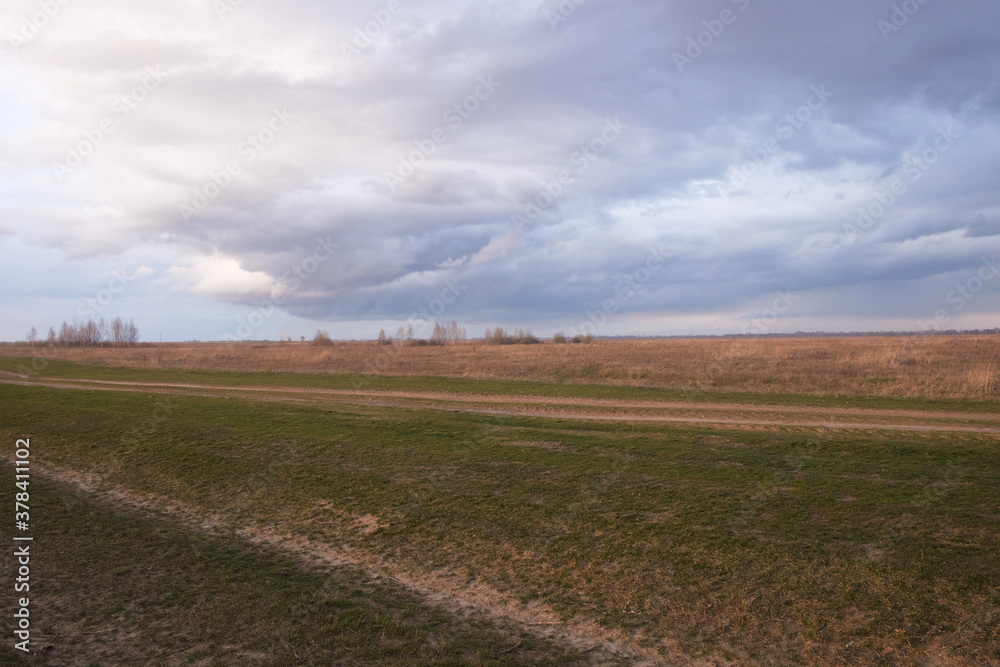 Dramatic pre-storm sky over the field. Spring landscape. Dramatic pre-storm sky over the field. Spring landscape.